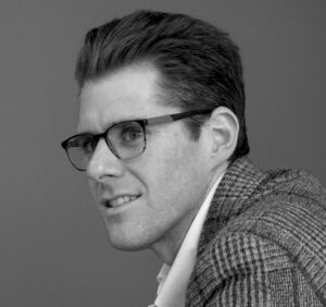 Black and white image of a man in glasses.